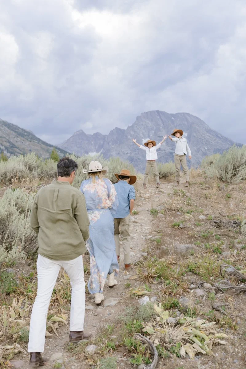  Family hiking together beneath the Teton Mountains during their Jackson Hole vacation 