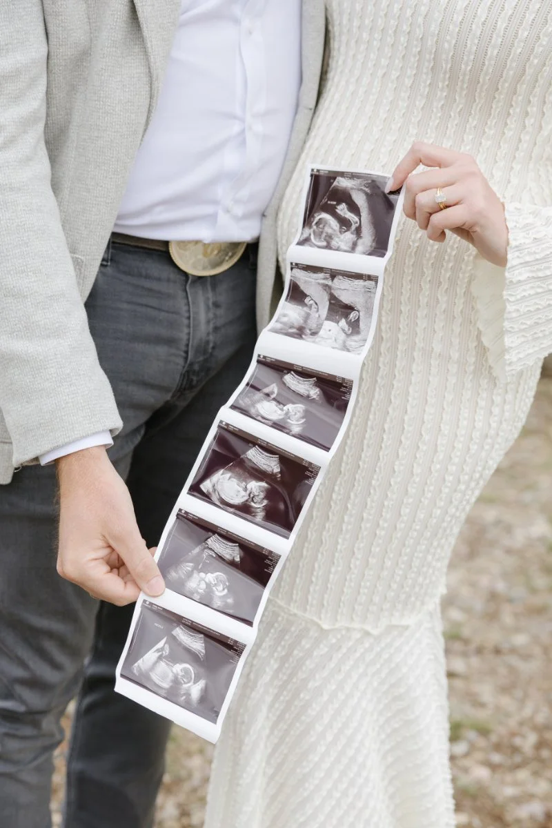  Pregnancy photo announcement with ultrasound photos during a Jackson Hole maternity session 