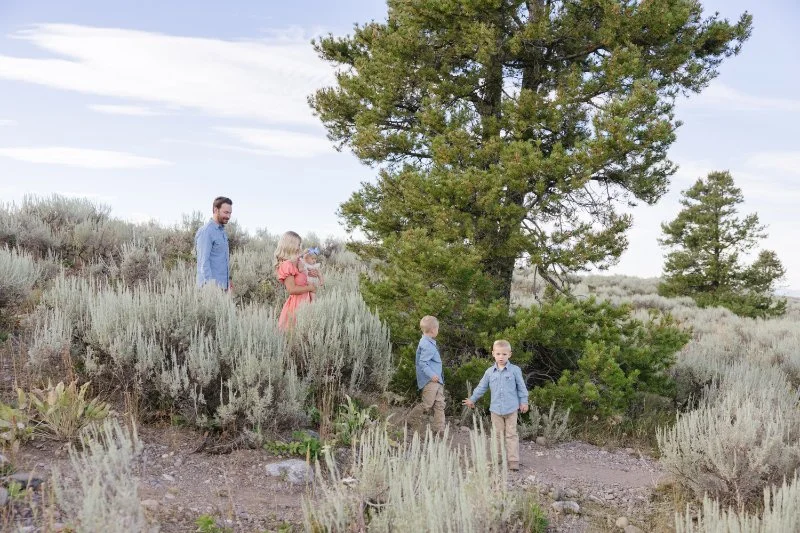 Family exploring the trails together while traveling with babies in Grand Teton National Park during a summer family vacation.
