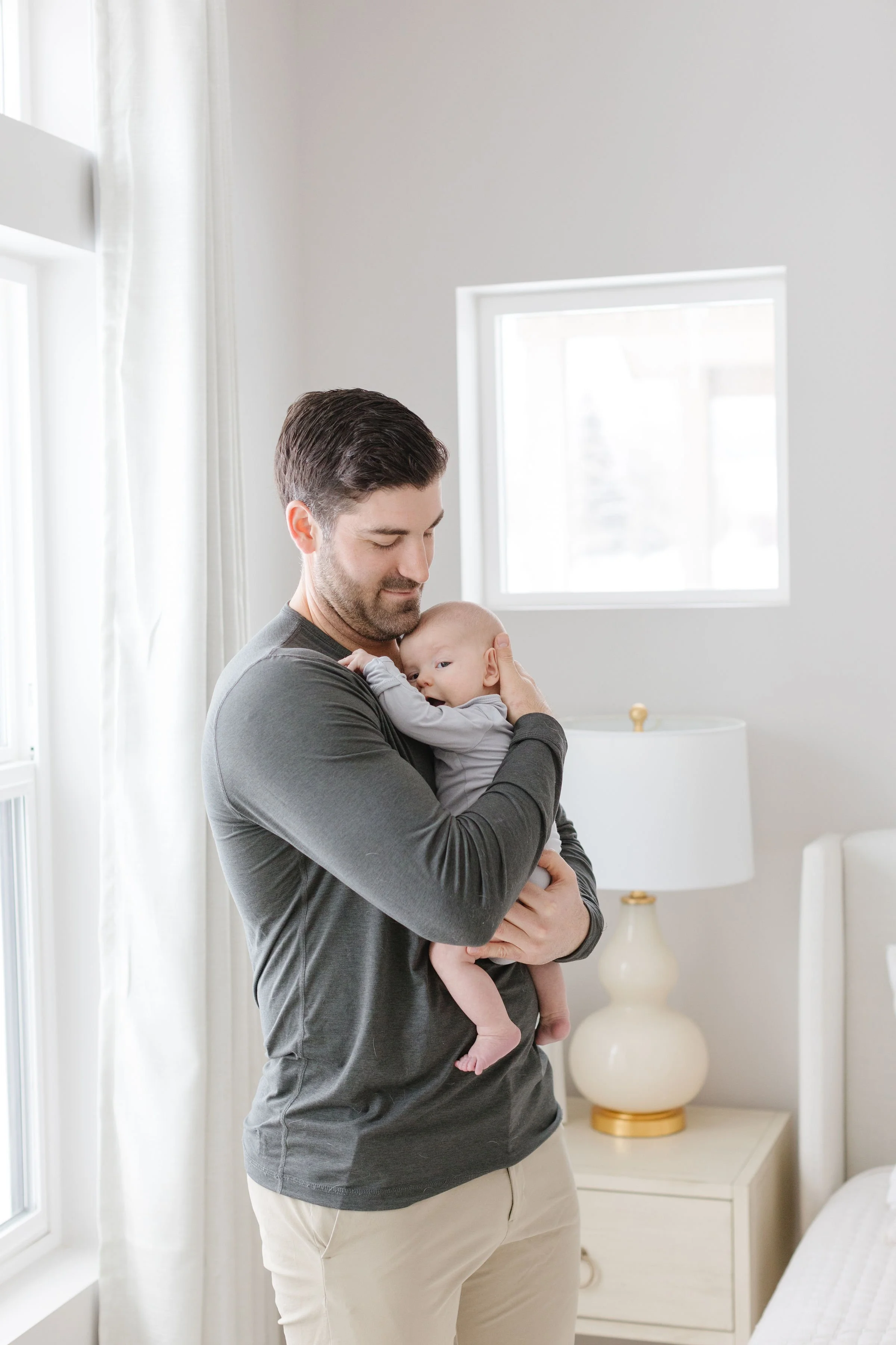 a new dad standing with his baby - Jackson Hole Newborn Photographer