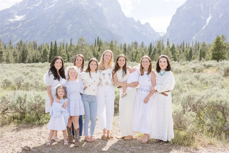 Women coordinate their outfits for adult family photography session in Jackson Hole.
