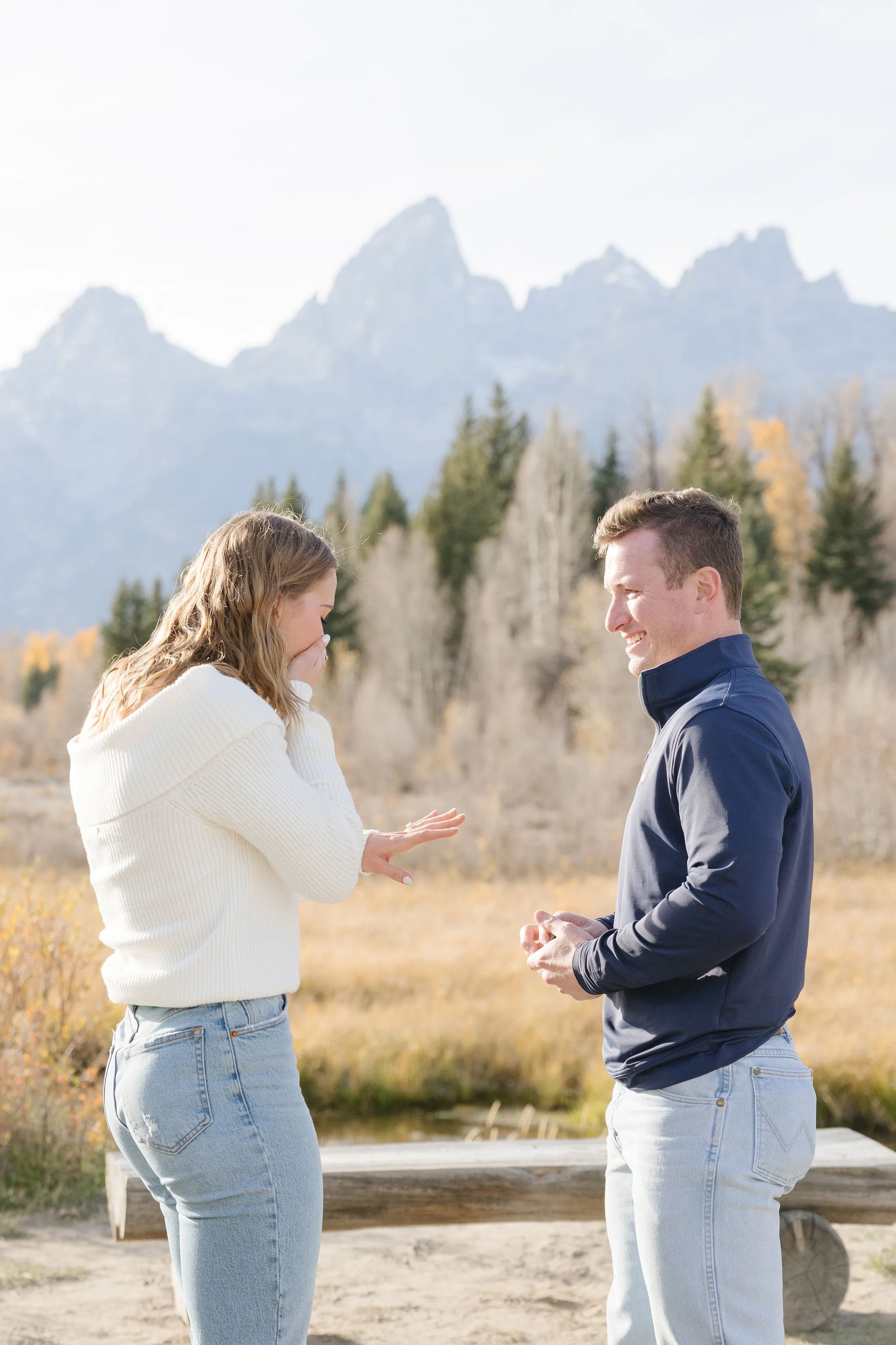 Girl admires engagement ring after her boyfriend planned a surprise proposal in Jackson Hole.