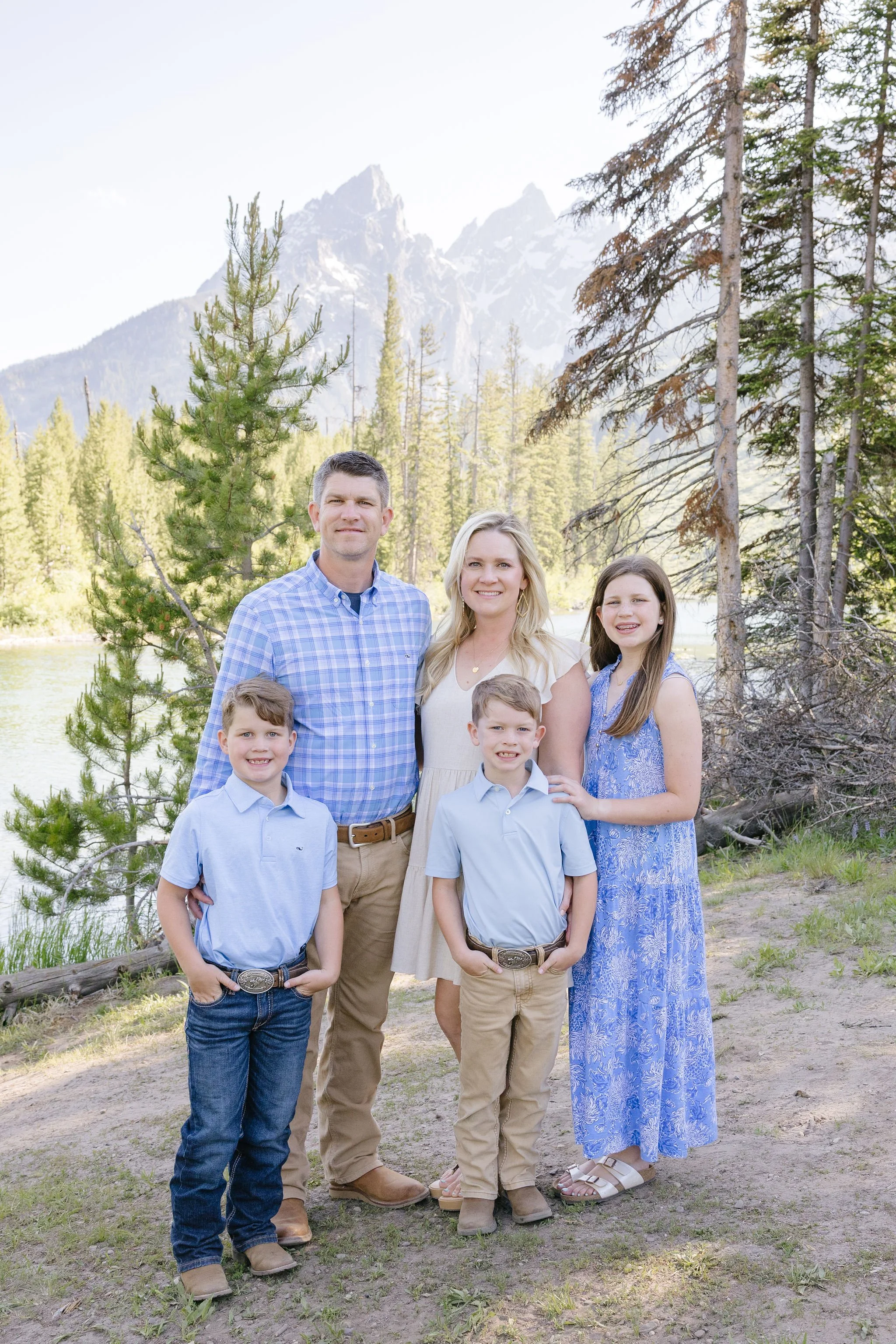 Family takes portraits with local photographer during their stay at the Four Seasons Resort Jackson Hole Teton Village.