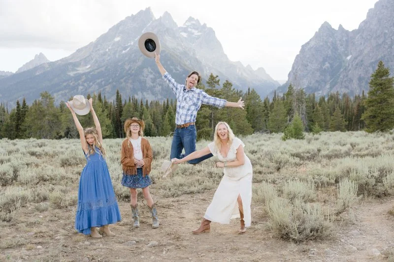 Family enjoying a Jackson Hole photography session with the Grand Teton Mountains in the background