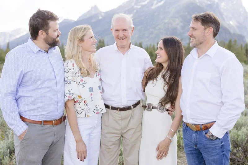 Father poses with children during adult family photography session in Jackson Hole.