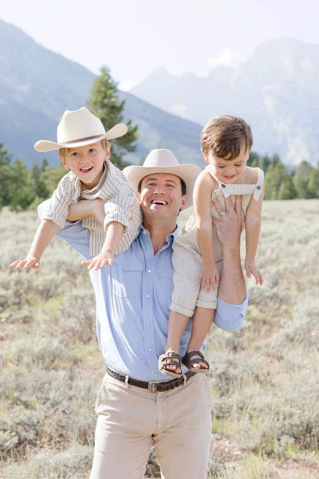 Father holding his two son for a family photo.