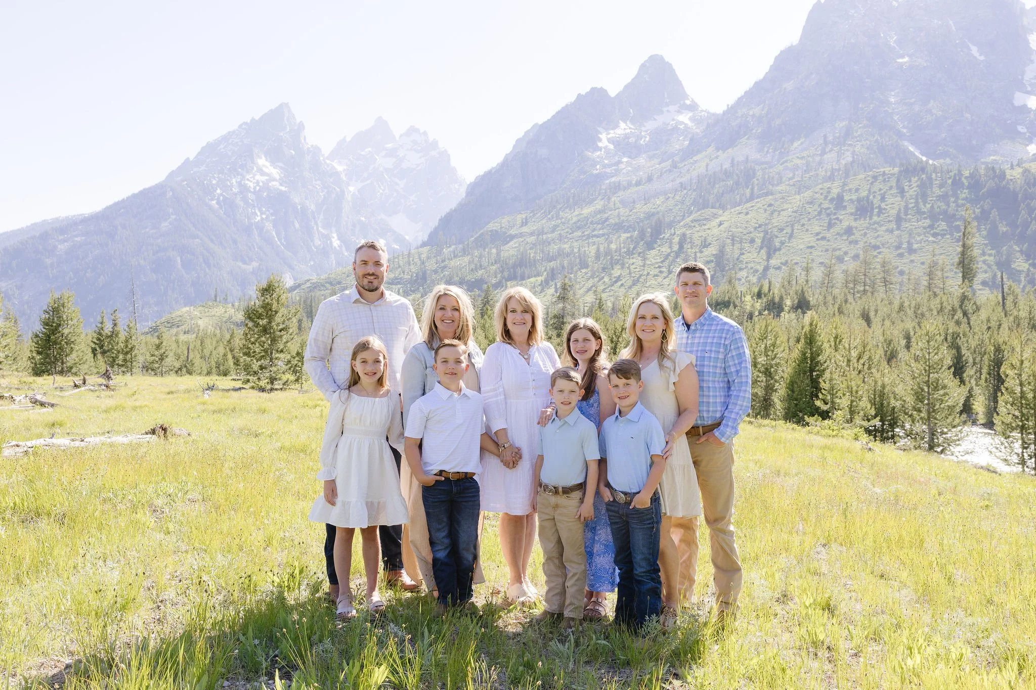 Extended family members take portraits with local photographer during their stay at the Four Seasons Resort Jackson Hole Teton Village.