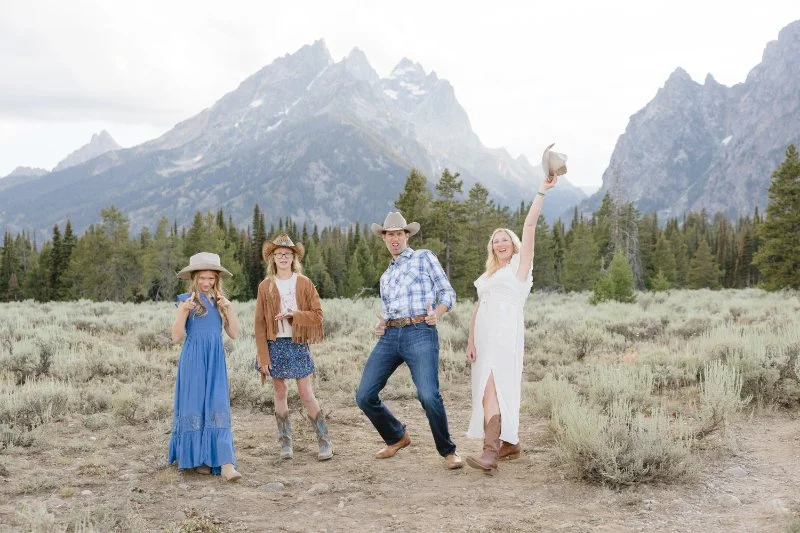 Grand Teton wildflowers family photos with cowboy hats and mountain views in Jackson Hole