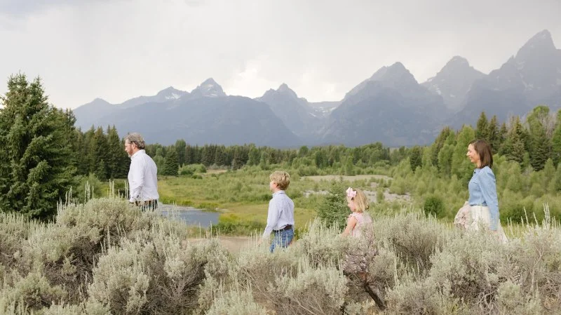 Family at the Grand Tetons with Kids walking through the meadow.