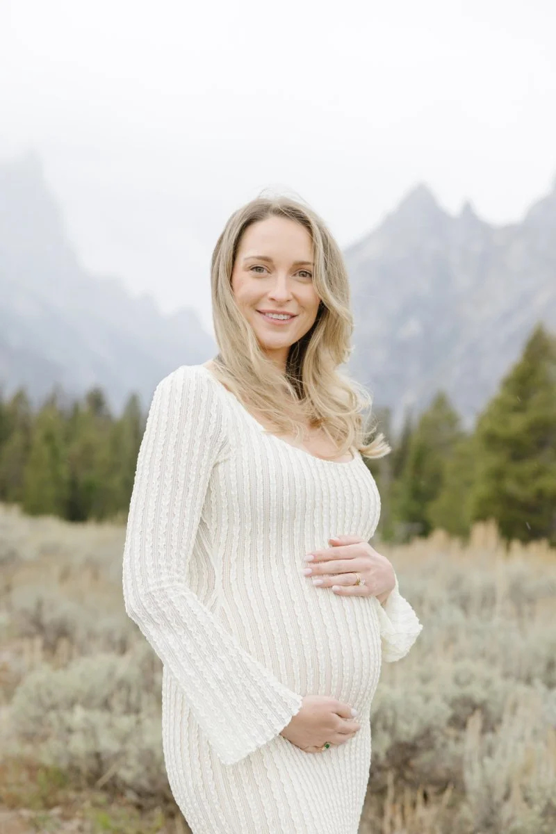 Expecting mother during a Jackson Hole pregnancy photo announcement session with Teton mountain views