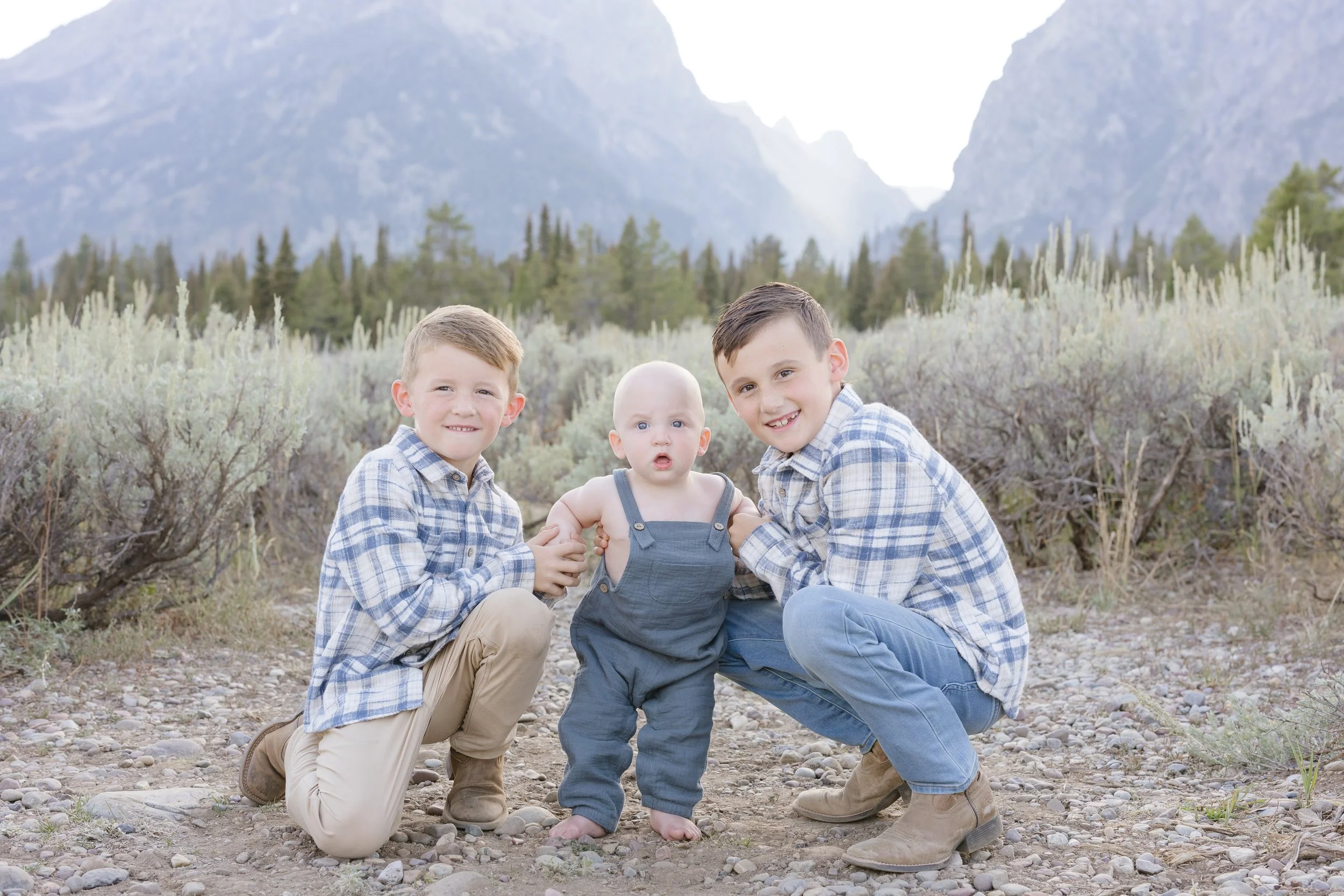 two big brothers kneeling down to their little brother - Why Photography Matters