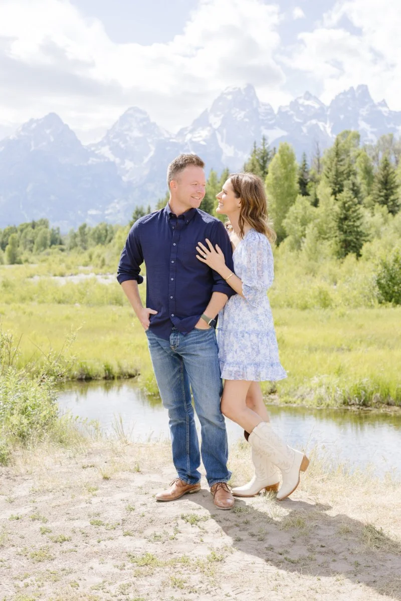 Couple looks into each others eyes as they pose for an adventurous couple sessions in Jackson Hole.