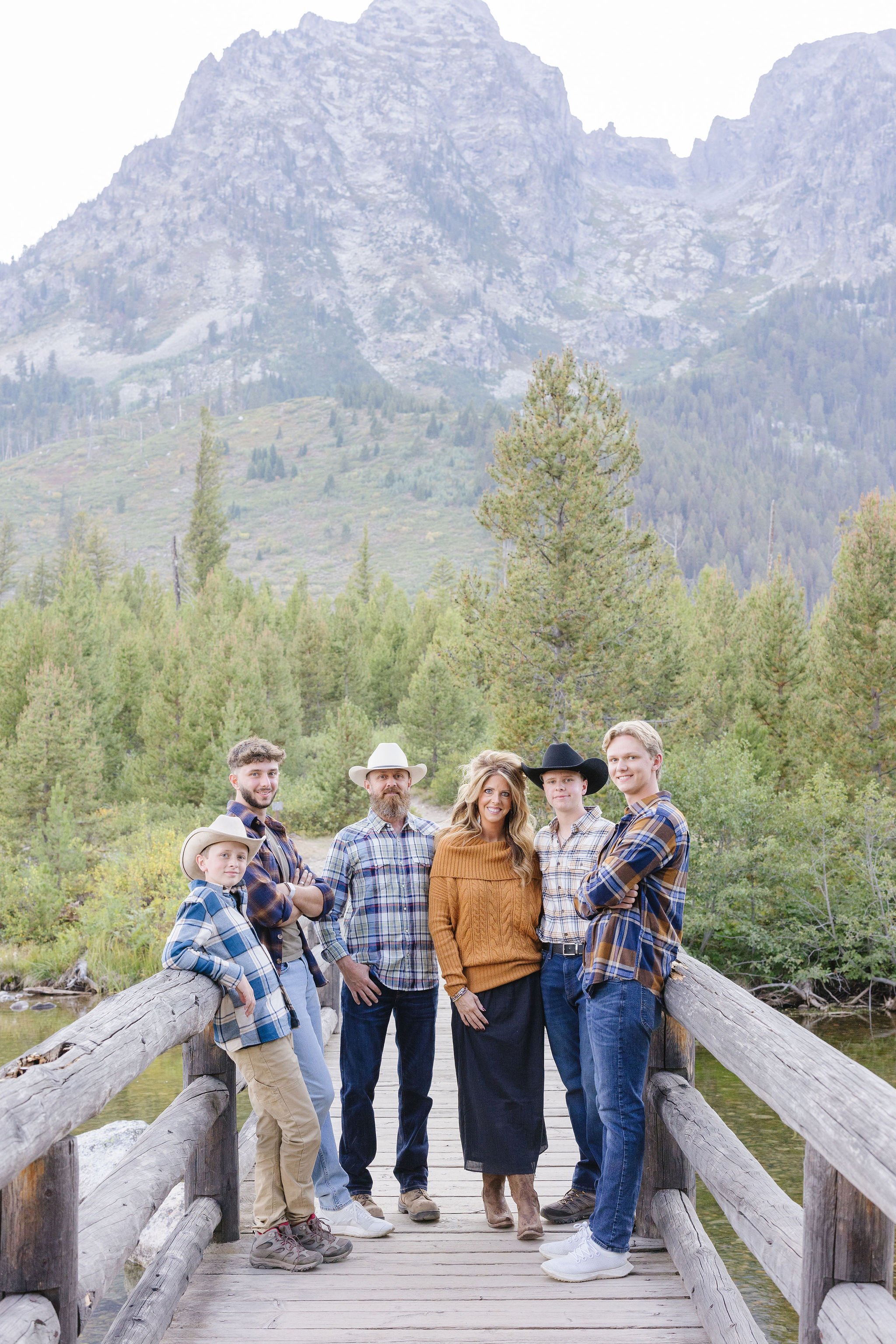 Family poses for photos together, one of the best things to do in Jackson Hole in the fall.