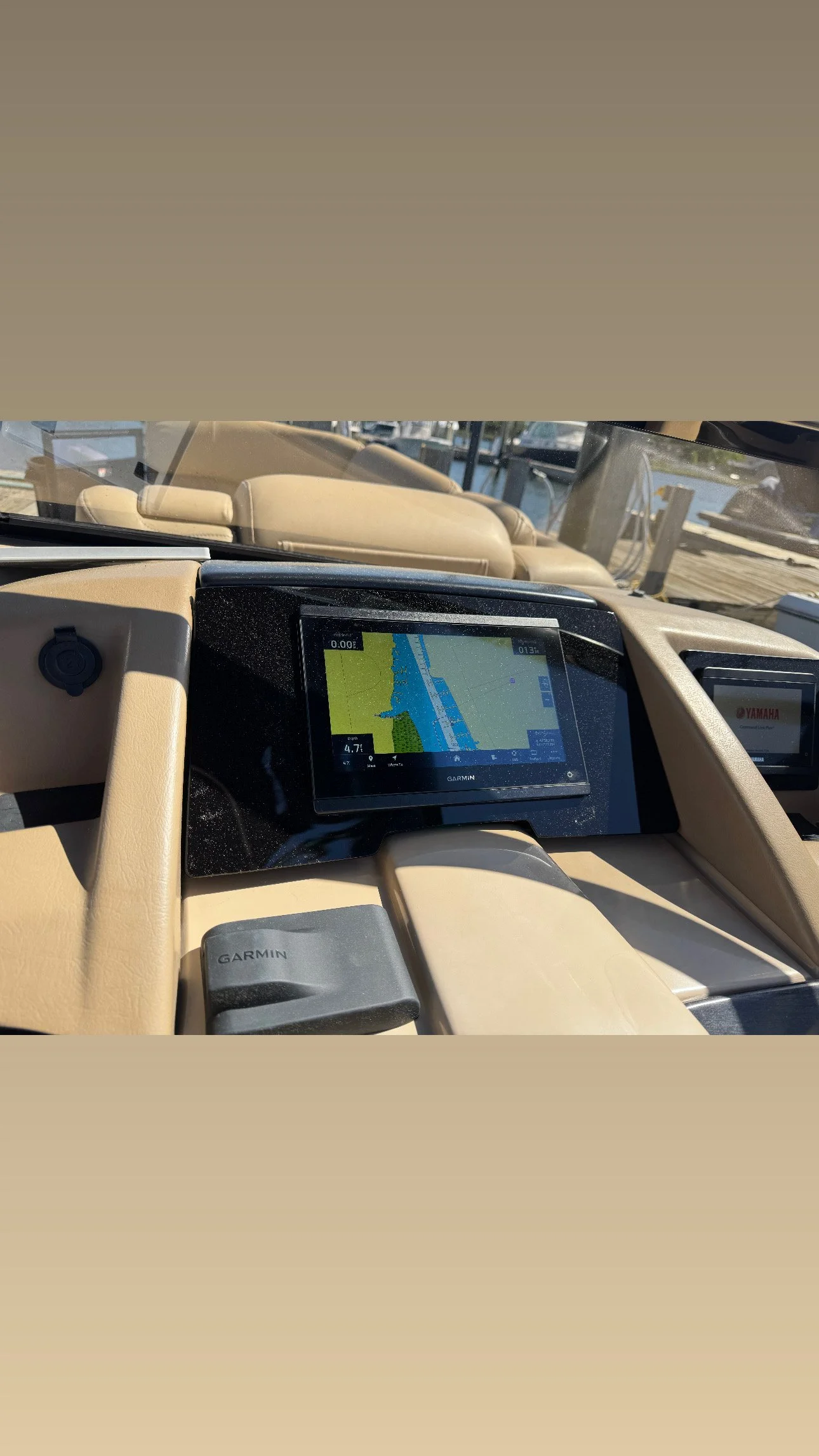 A GPS navigation system inside a boat showing a waterway with land on both sides.