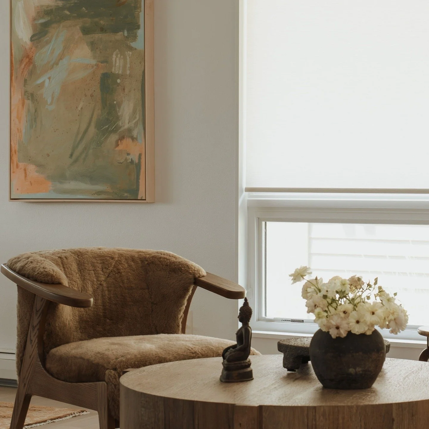 I loved working with this client to create a serene, neutral corner in her home&mdash;letting textures and wood grains do most of the work, but adding color through this stunning original @kristenabbott abstract and the richer burnt umber tones in th