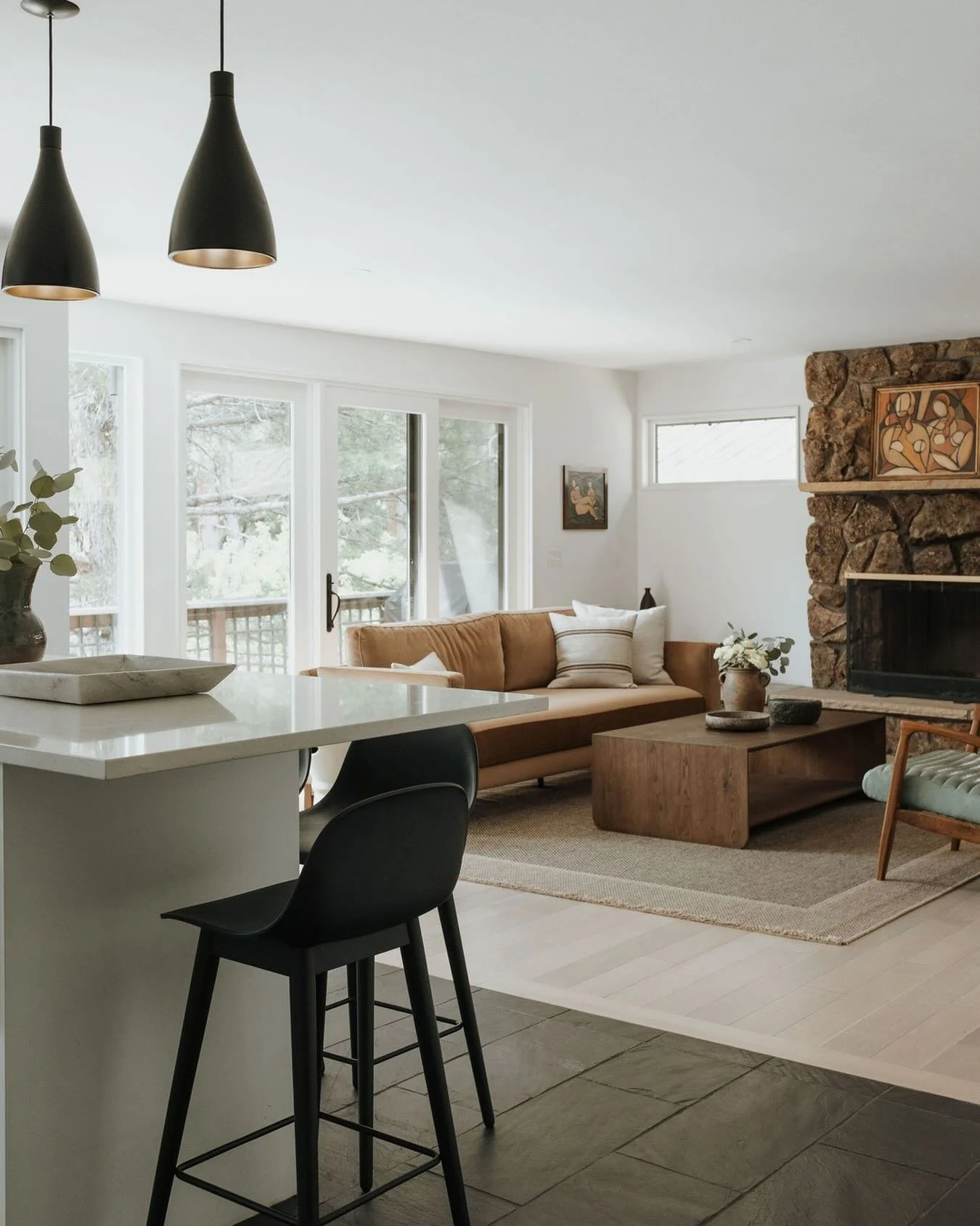 A little moodier, a little warmer, and a lot more livable.

This space had such a soft tonal palette already, so bringing in the darker pendants and stools was really about creating contrast and giving the room a bit more grounding and rhythm. The st