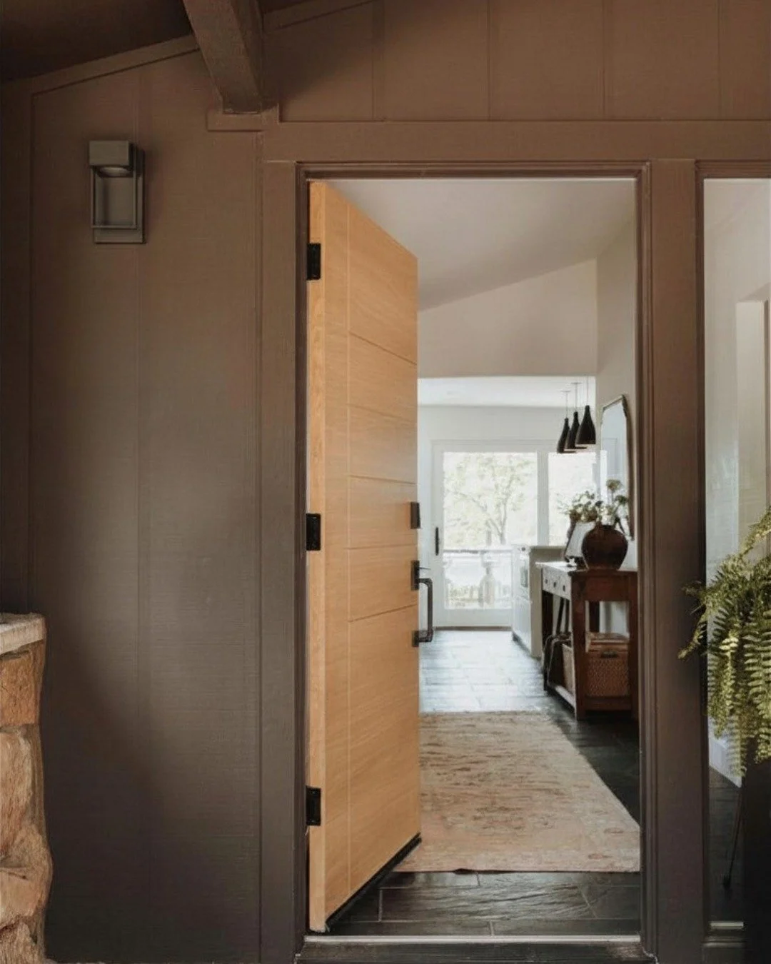 A few thoughtful updates completely changed the feel of this entry. We updated the light fixture and brought everything into dark sky compliance, replaced the front door, added a planter for a touch of warmth and greenery, and introduced softer tones