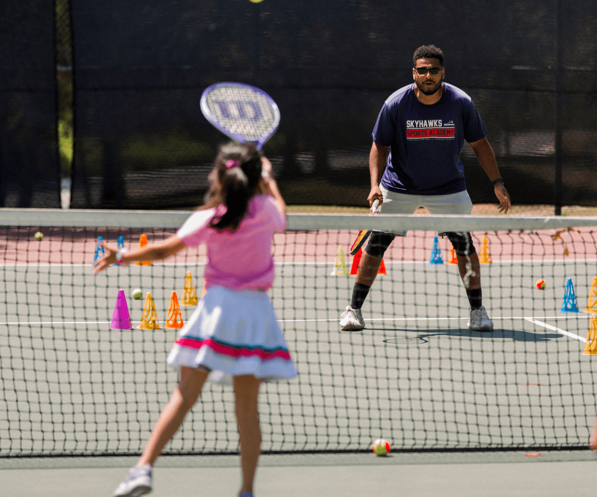 Skyhawks summer camp coach leading children