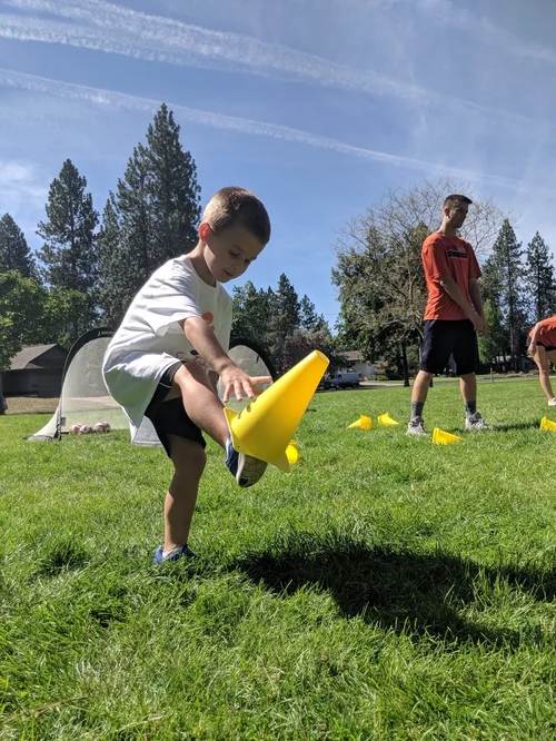 Children learning soccer skills