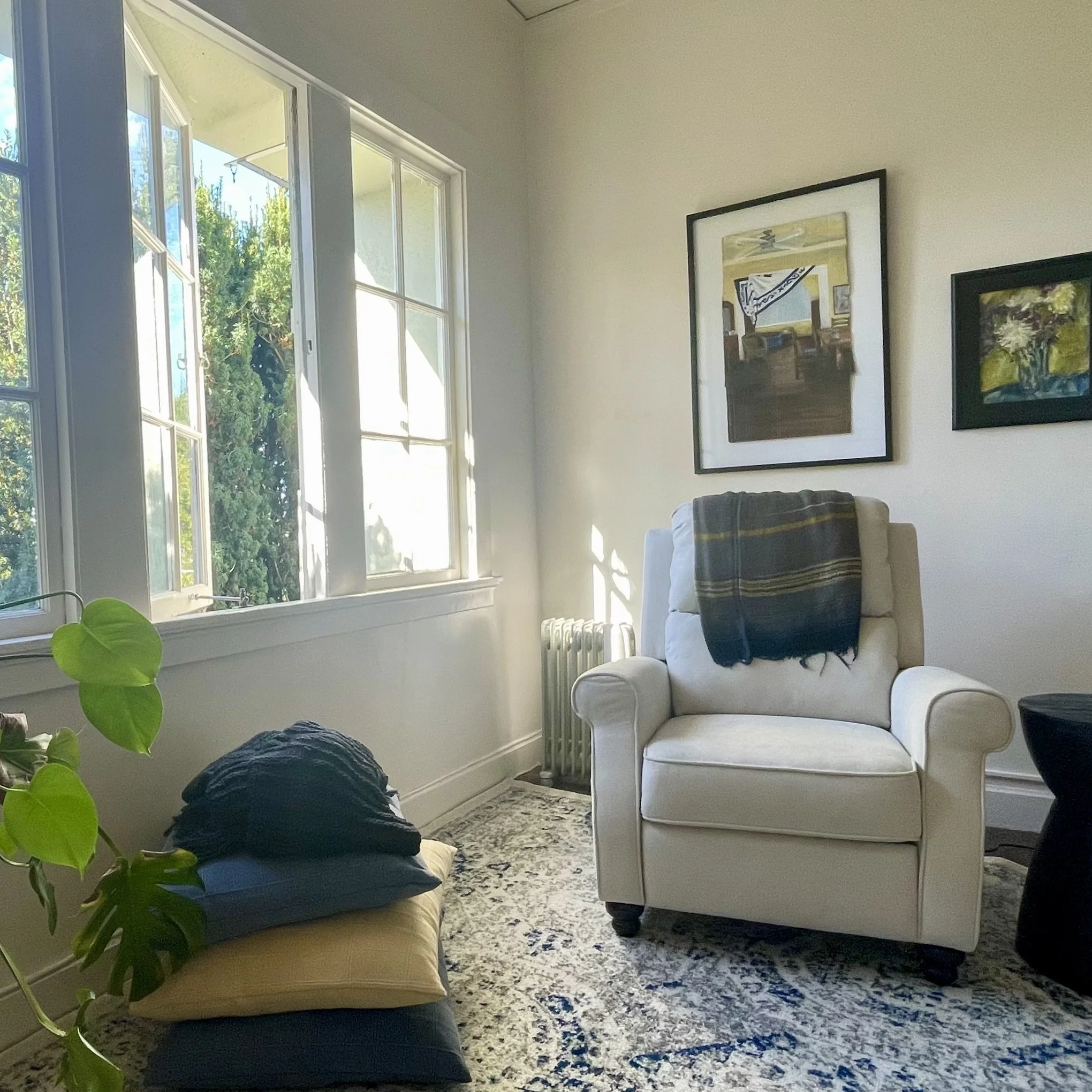 Therapist chair with art, plants and windows