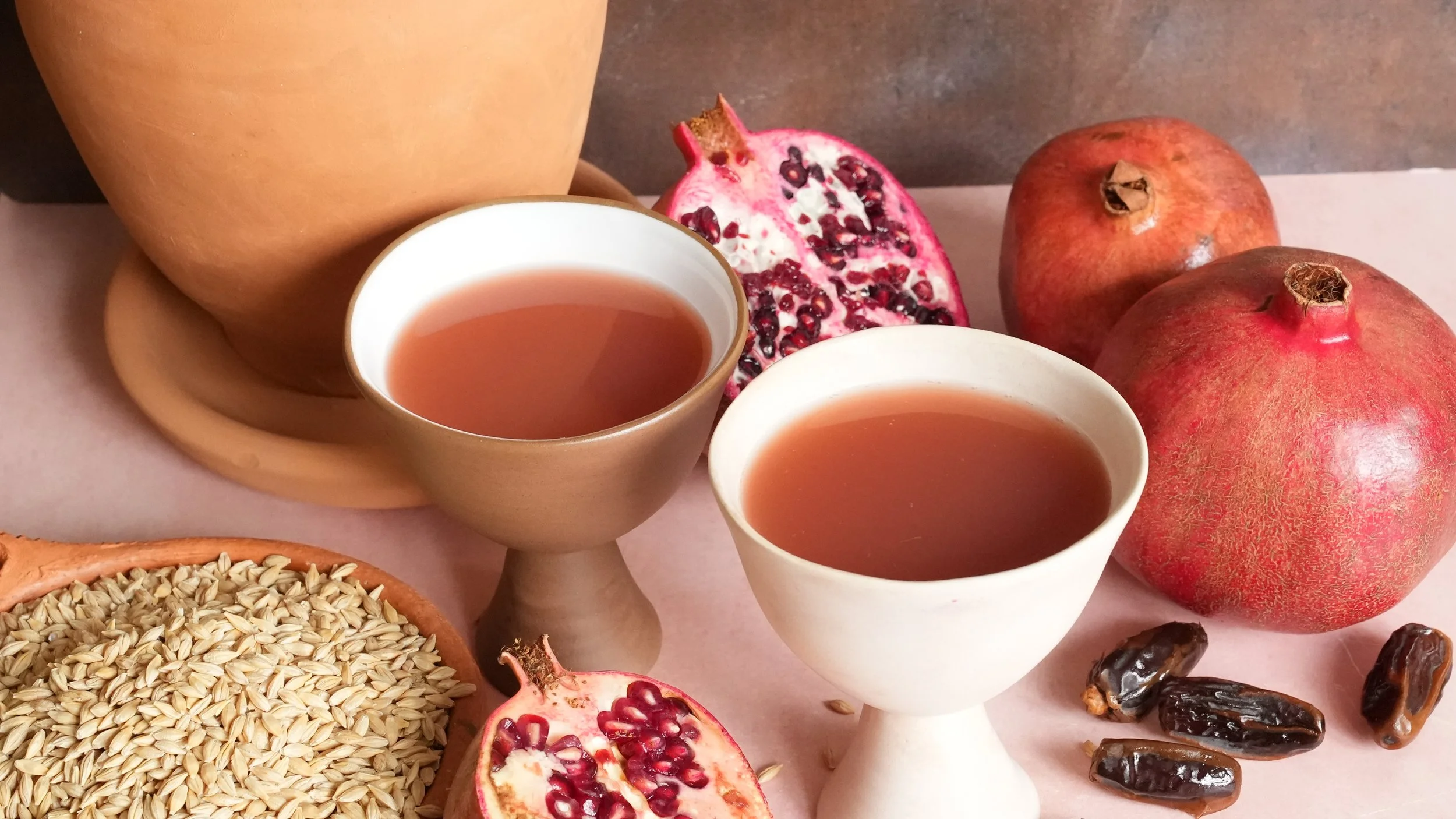brownish-red cloudy beer with pomegranates dates and barley
