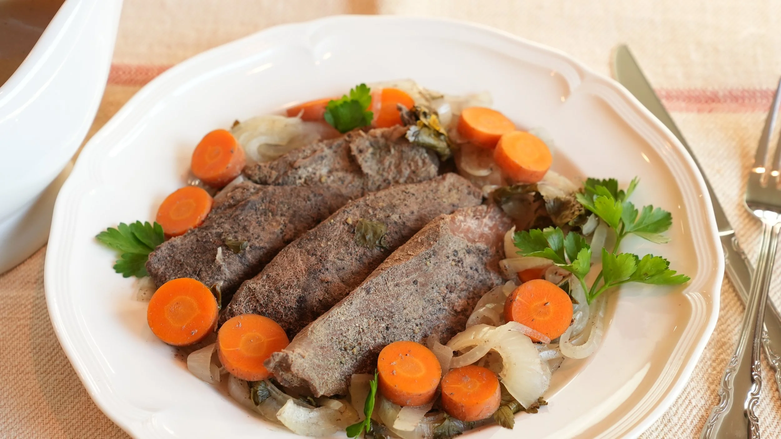 sliced braised kangaroo steak sliced carrots onions parsley and gravy