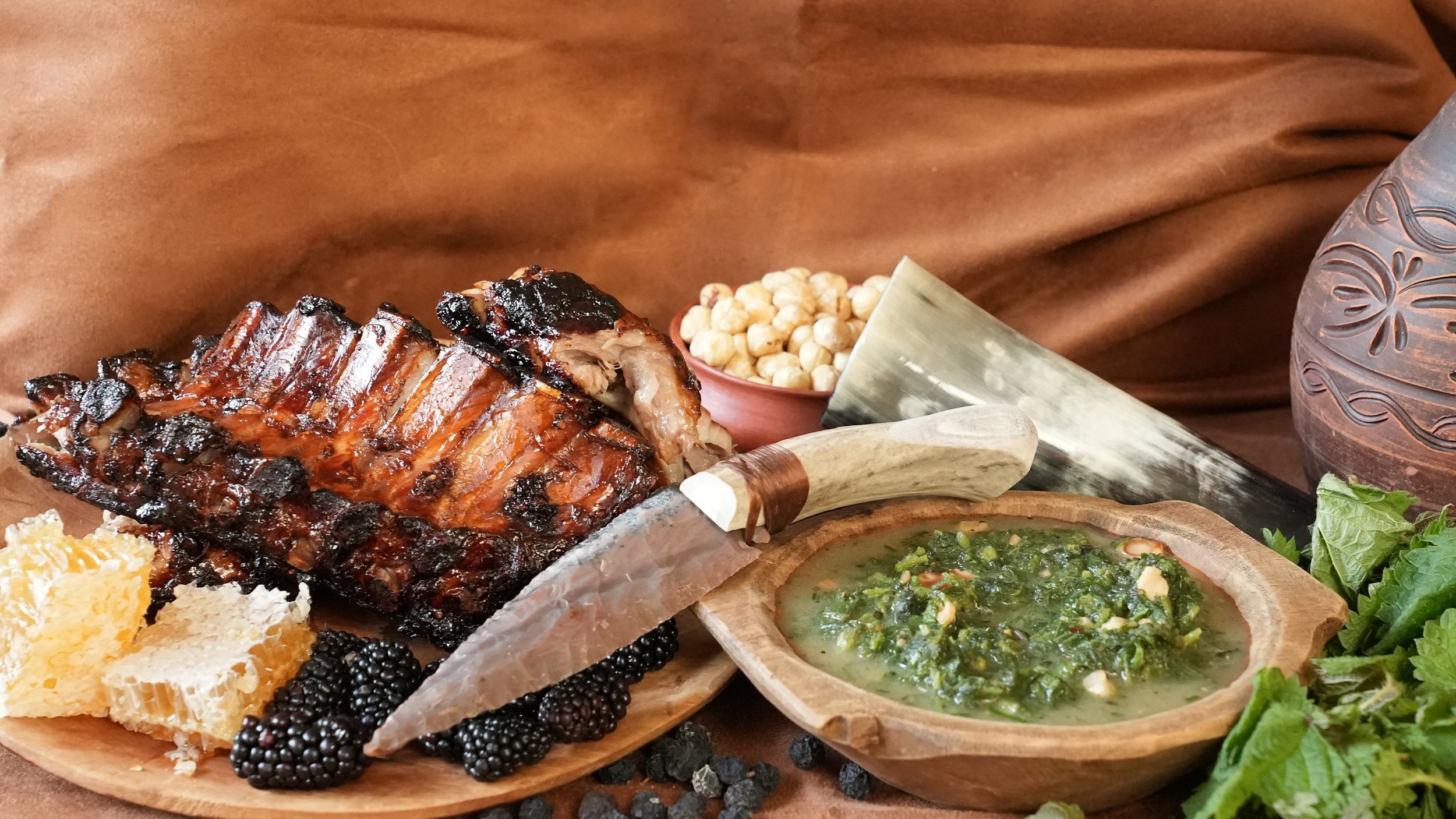 pork ribs roasted with honey and blackberries with green soup of nettles hazelnuts chives