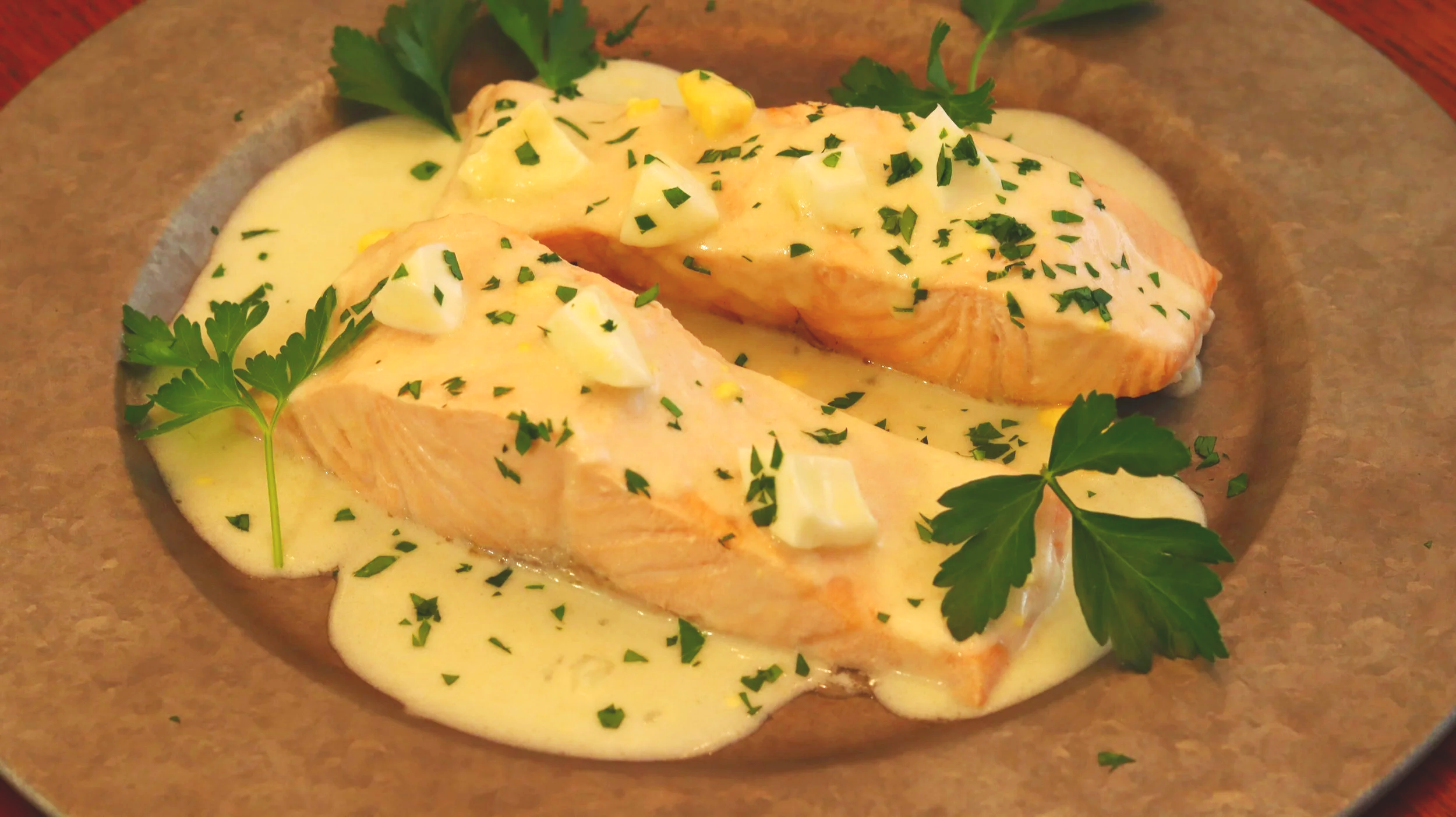 poached salmon in creamy sauce with chopped parsley and hard boiled egg