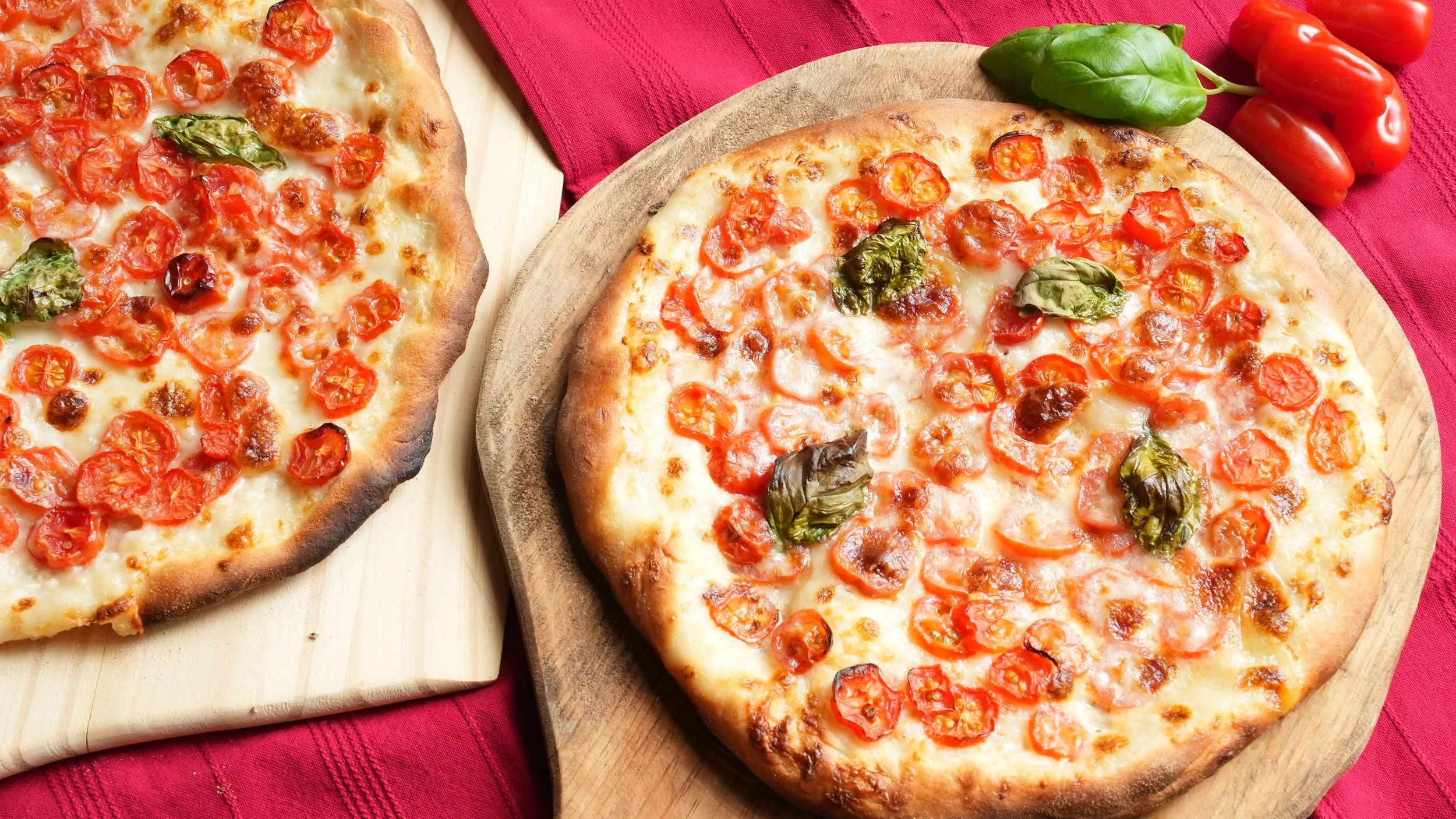 pizza topped with sliced tomatoes basil mozzarella