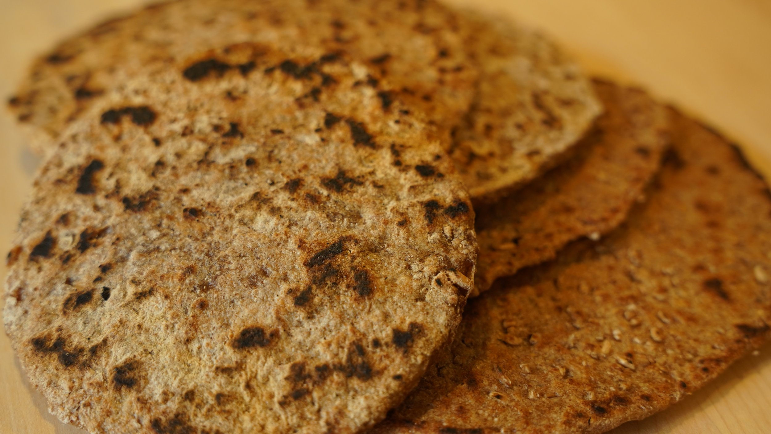round flatbreads cooked on a griddle
