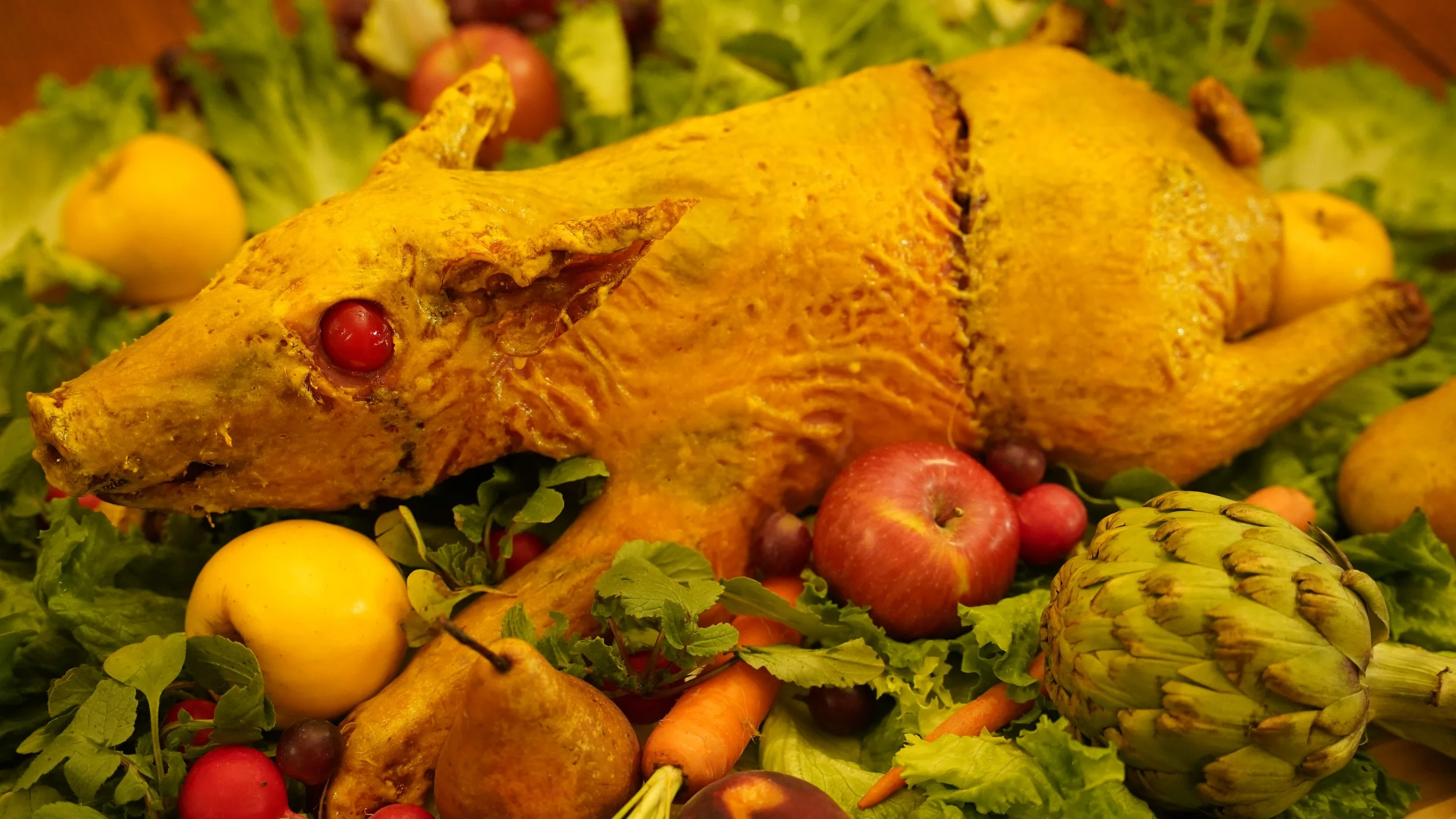 roasted front half of a suckling pig sewn onto the roasted back half of a capon covered in a golden coating