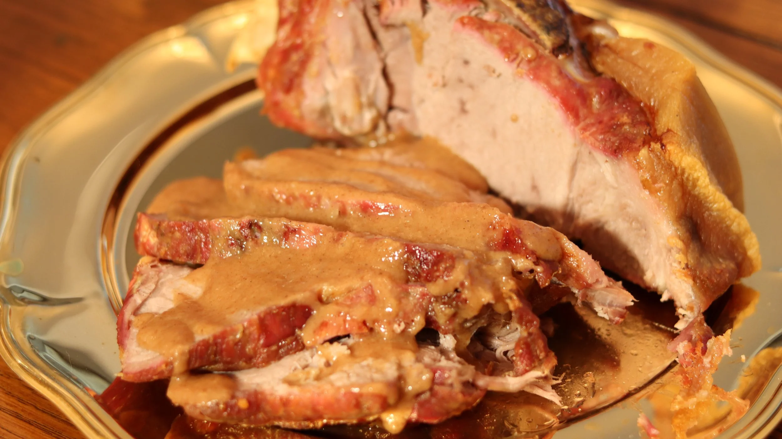 roasted pork shoulder with thick light brown galyntyne sauce