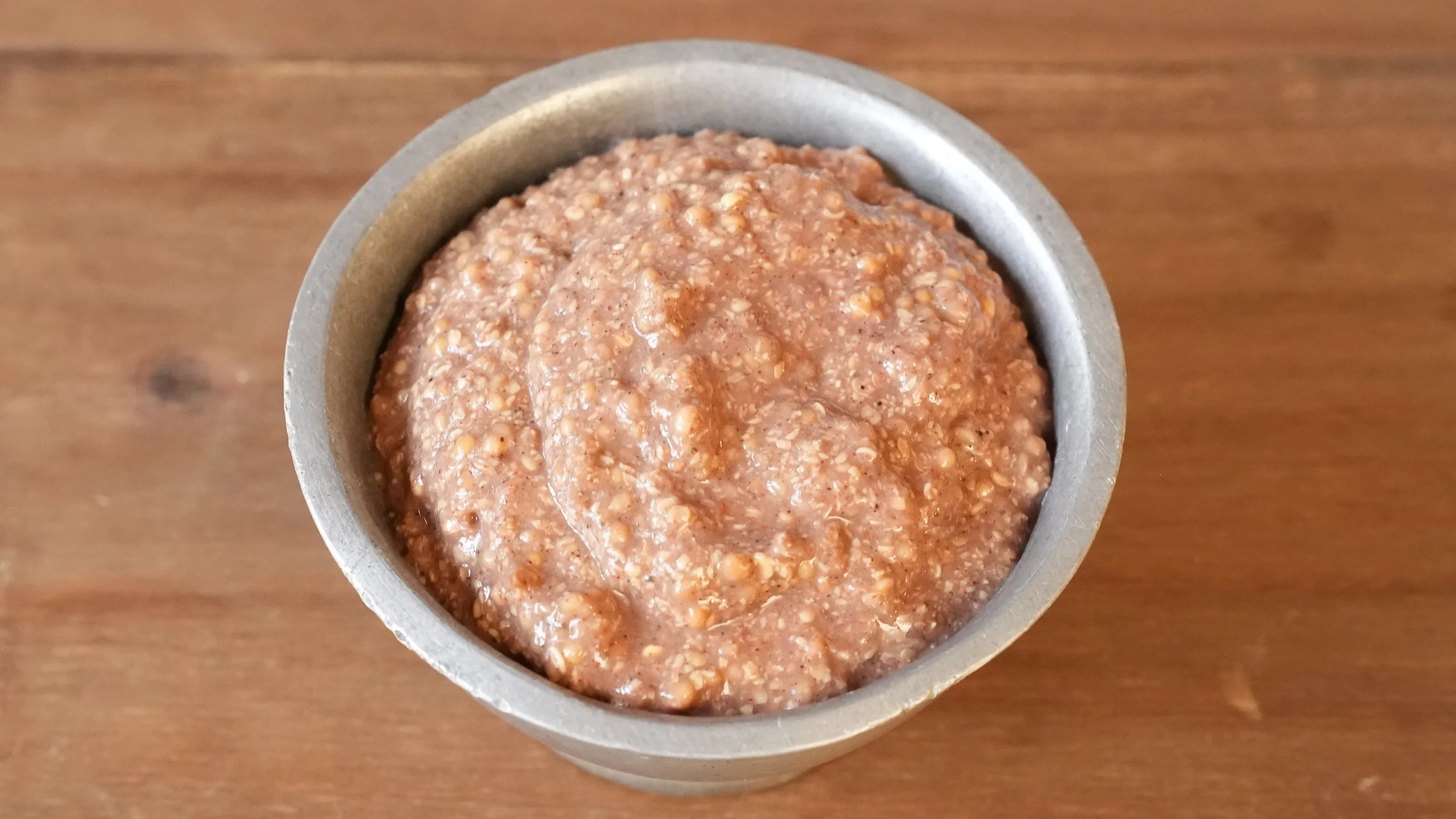 thick coarse ground mustard with warm spices in a small metal bowl