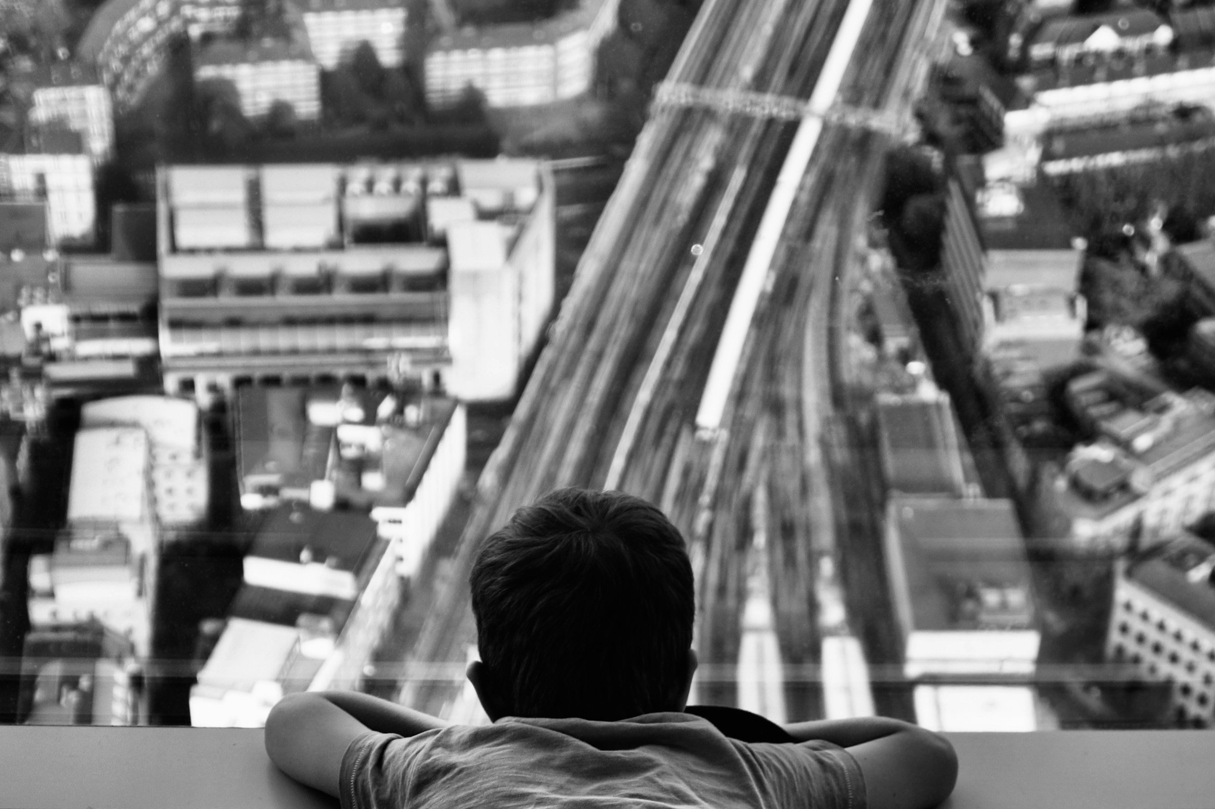 A child looks out over a railway between buildings, to symbolise how people's perspectives affect how they experience the world