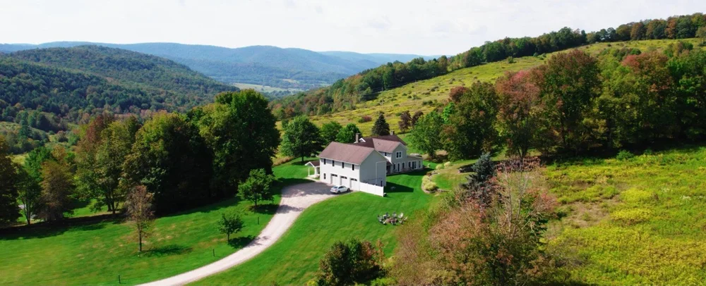 Aerial view of Stonewall Estate surrounded by Catskill hills in Delancey, New York