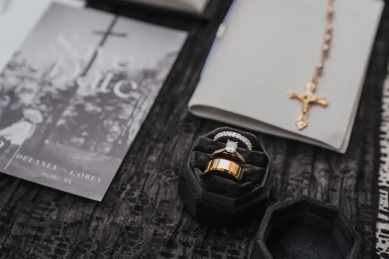 Wedding rings, invitation, and heirloom details arranged for a Stonewall Estate wedding