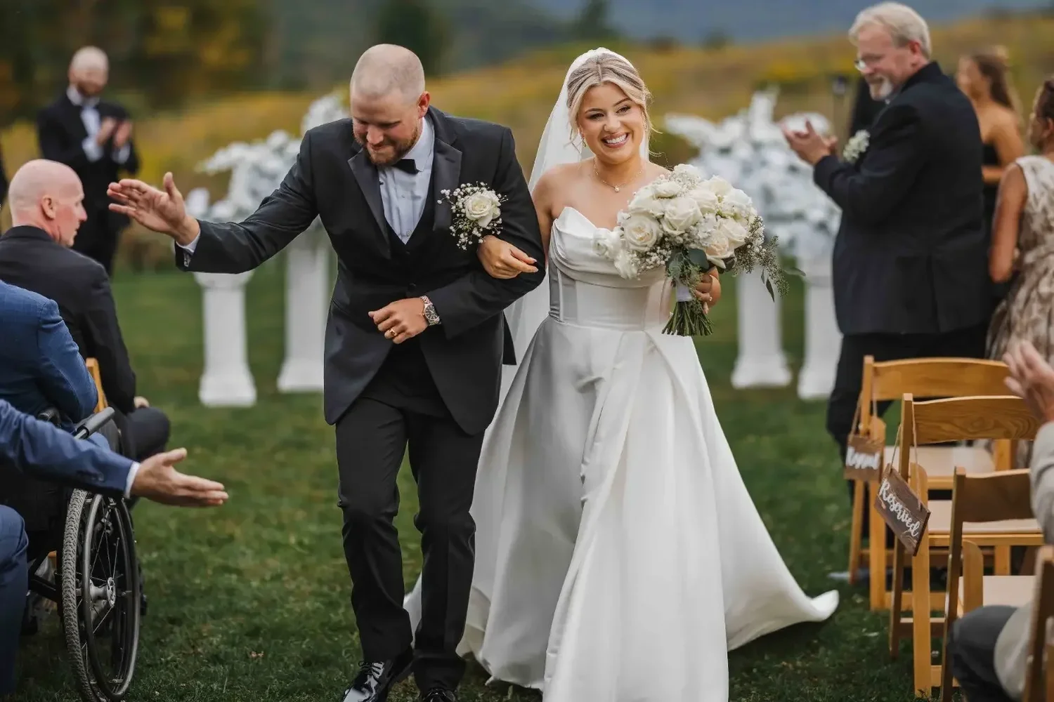 Newlyweds smiling during their recessional from Stonewall Estate's outdoor ceremony