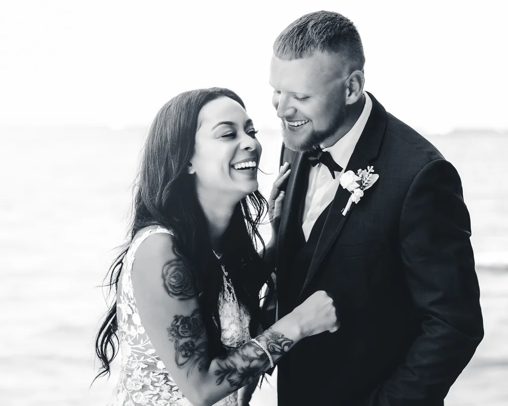 Newlyweds laughing together during their portrait session