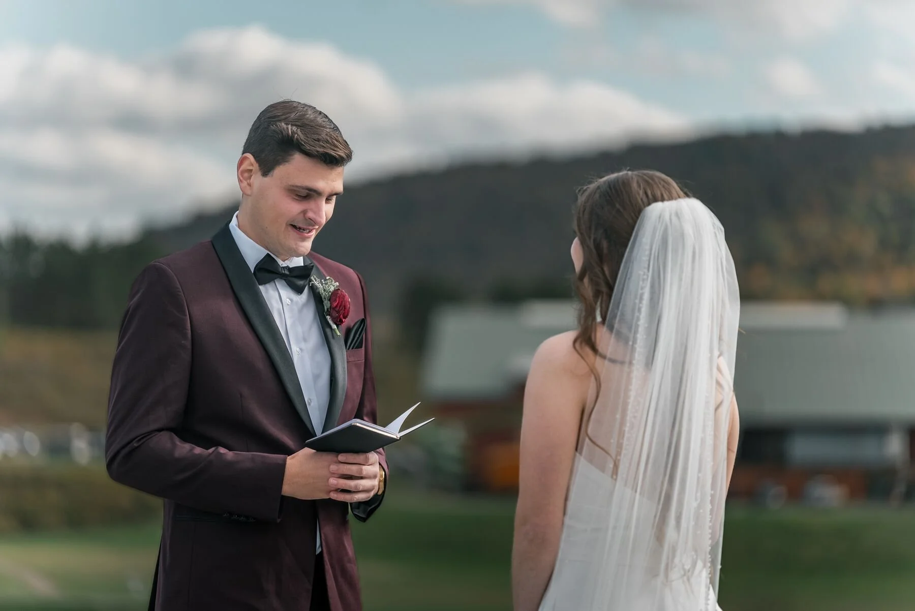 Couple reading private letters before their Greek Peak wedding ceremony