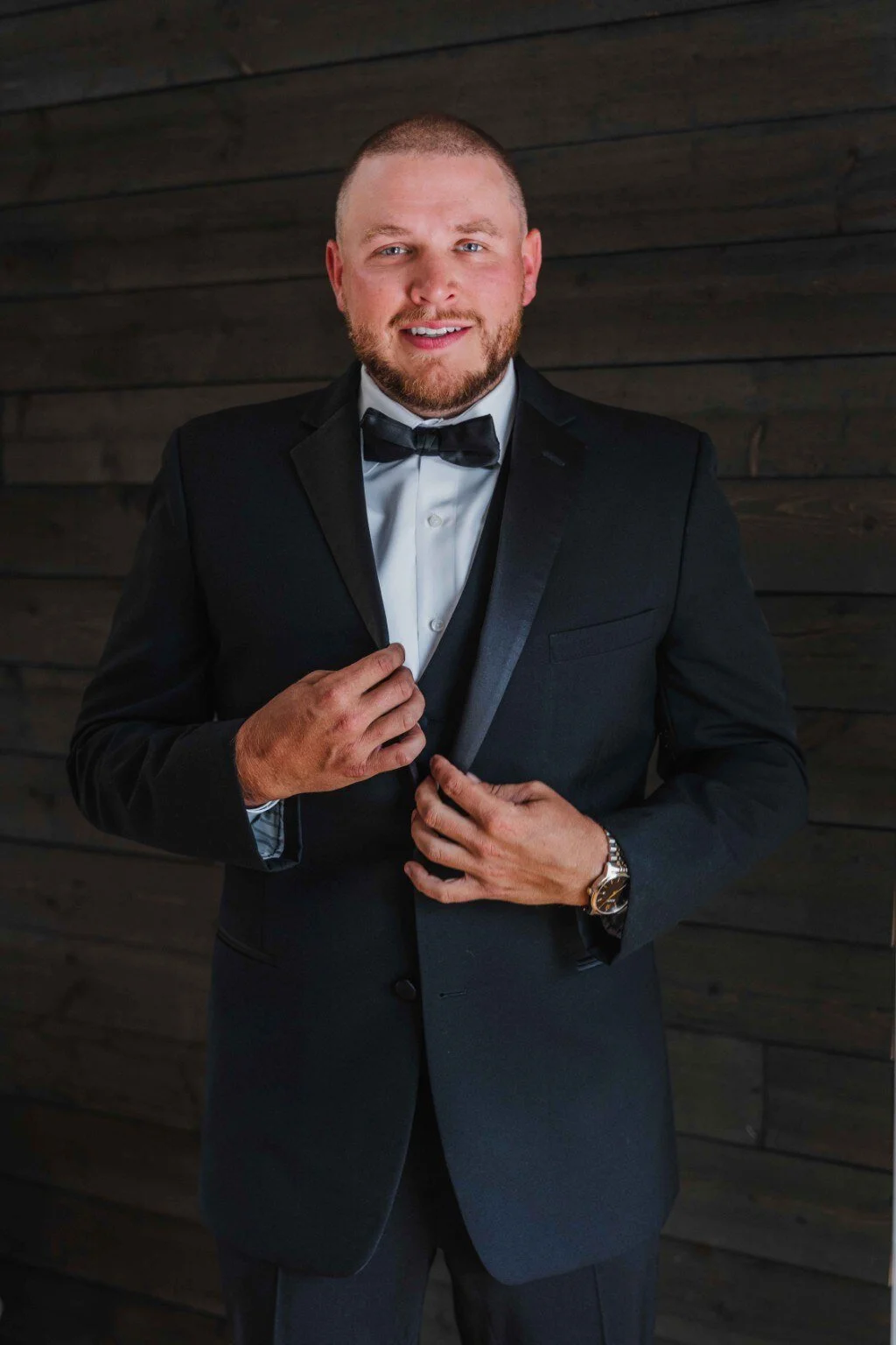 Groom adjusting his tuxedo before a Stonewall Estate wedding