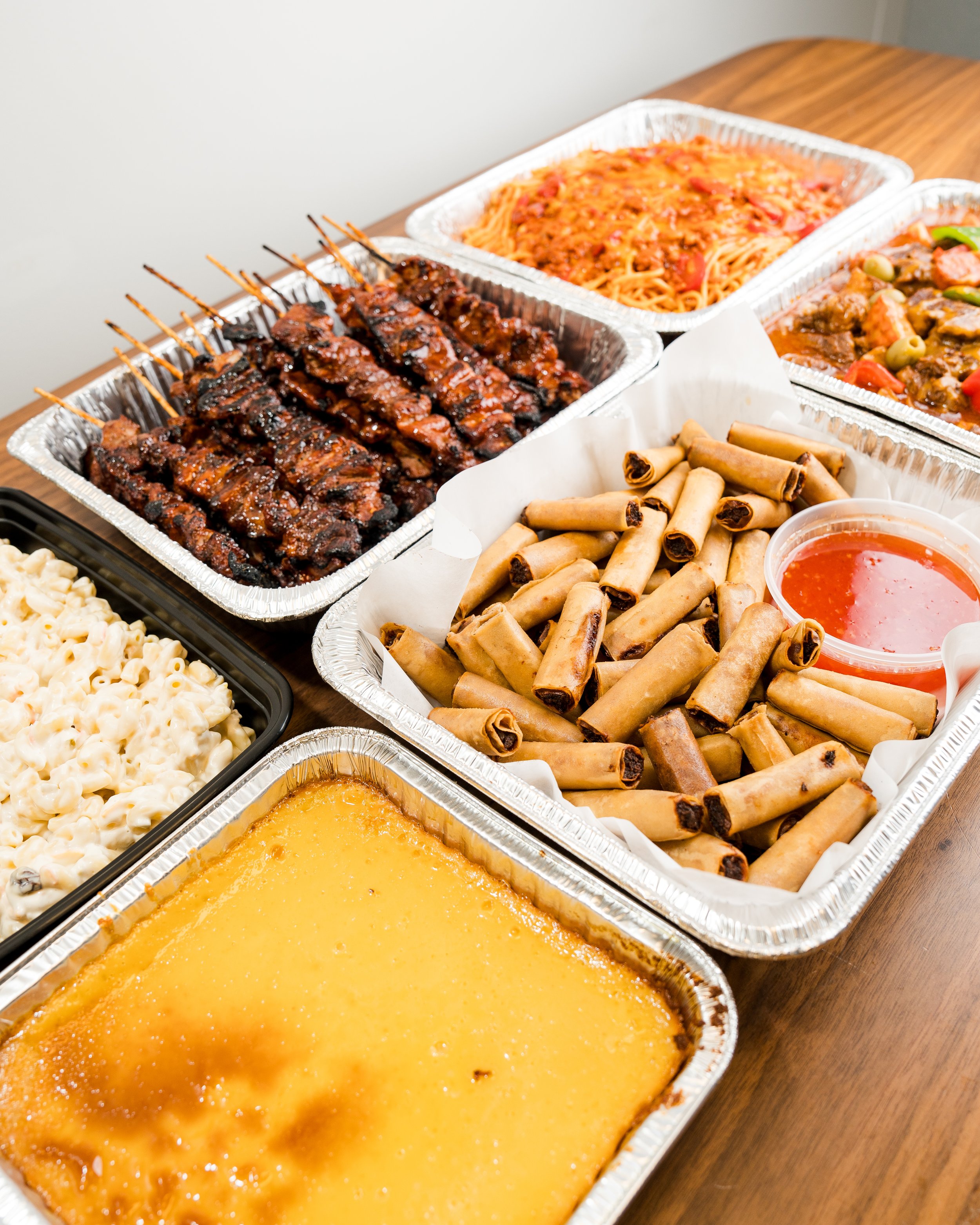 Filipino Food Party Catering, including a medium tray of Filipino Barbeque, Beef Caldereta, Leche Flan, Pork Lumpia, Filipino Spaghetti and Mac Salad