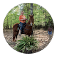 A person riding a horse in a wooded outdoor setting.