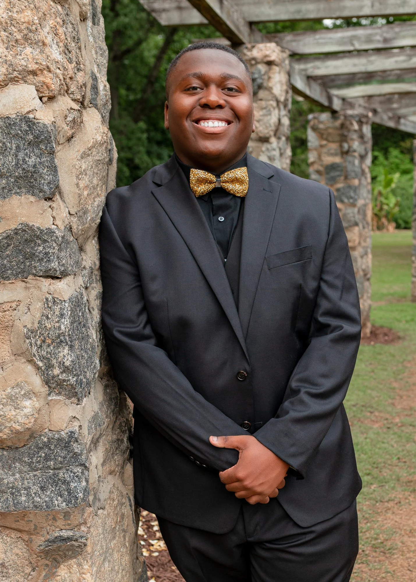 A high school student poses for a photo during a portrait photo shoot before prom in Raleigh, North Carolina