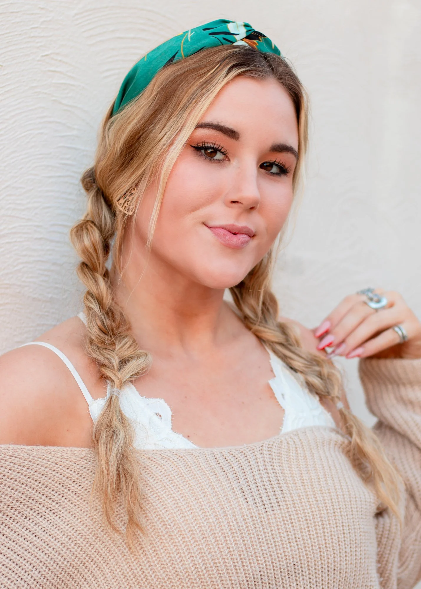 A model poses and plays with her hair during a portrait session in Downtown Raleigh.  The portrait session was shot by PixByDez Photography.