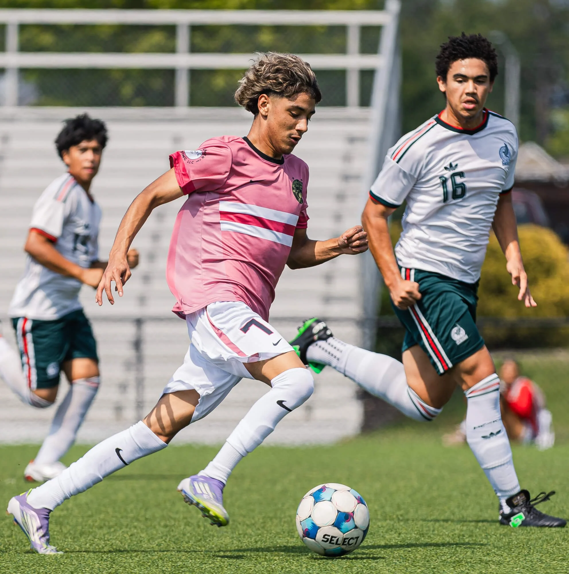 A player for FC ORO U18 boys team dribble past an opposing team player during a soccer game in Raleigh, NC