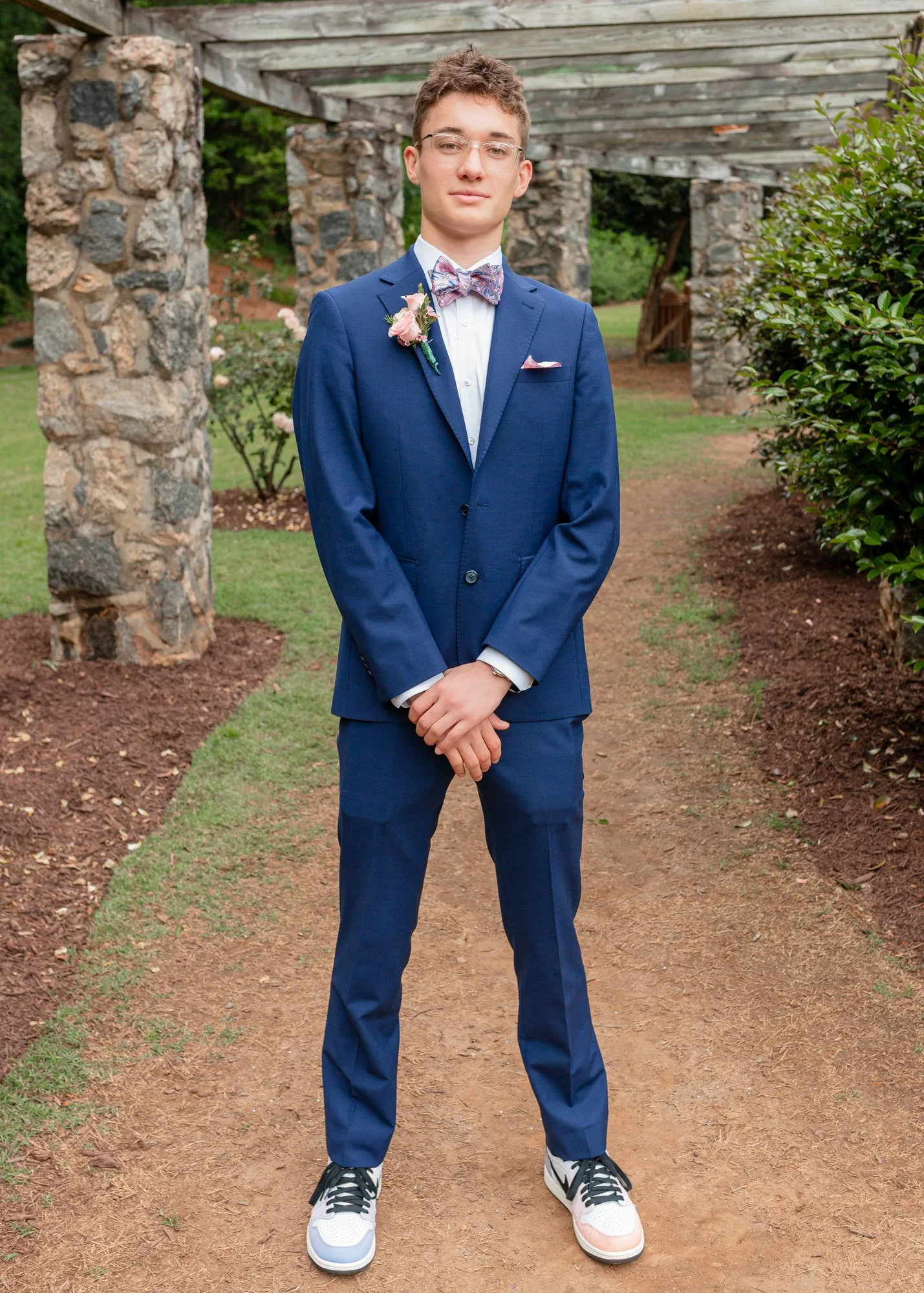 A male high school student poses for a photo during a portrait photo shoot before prom in Raleigh, NC