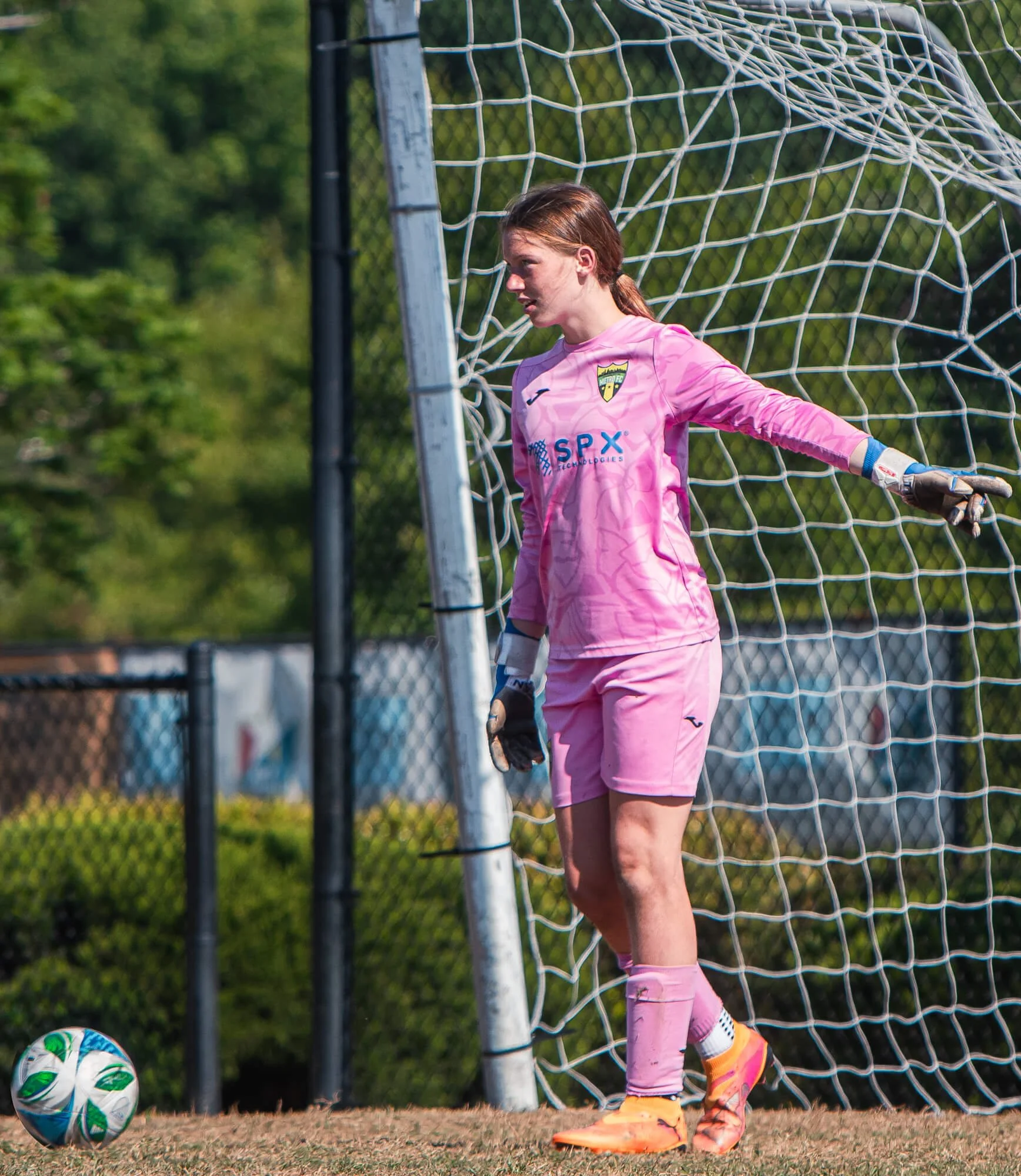A goalie for a Charlotte Metro FC U13 girls team prepares to kick the ball during a game in Raleigh, NC