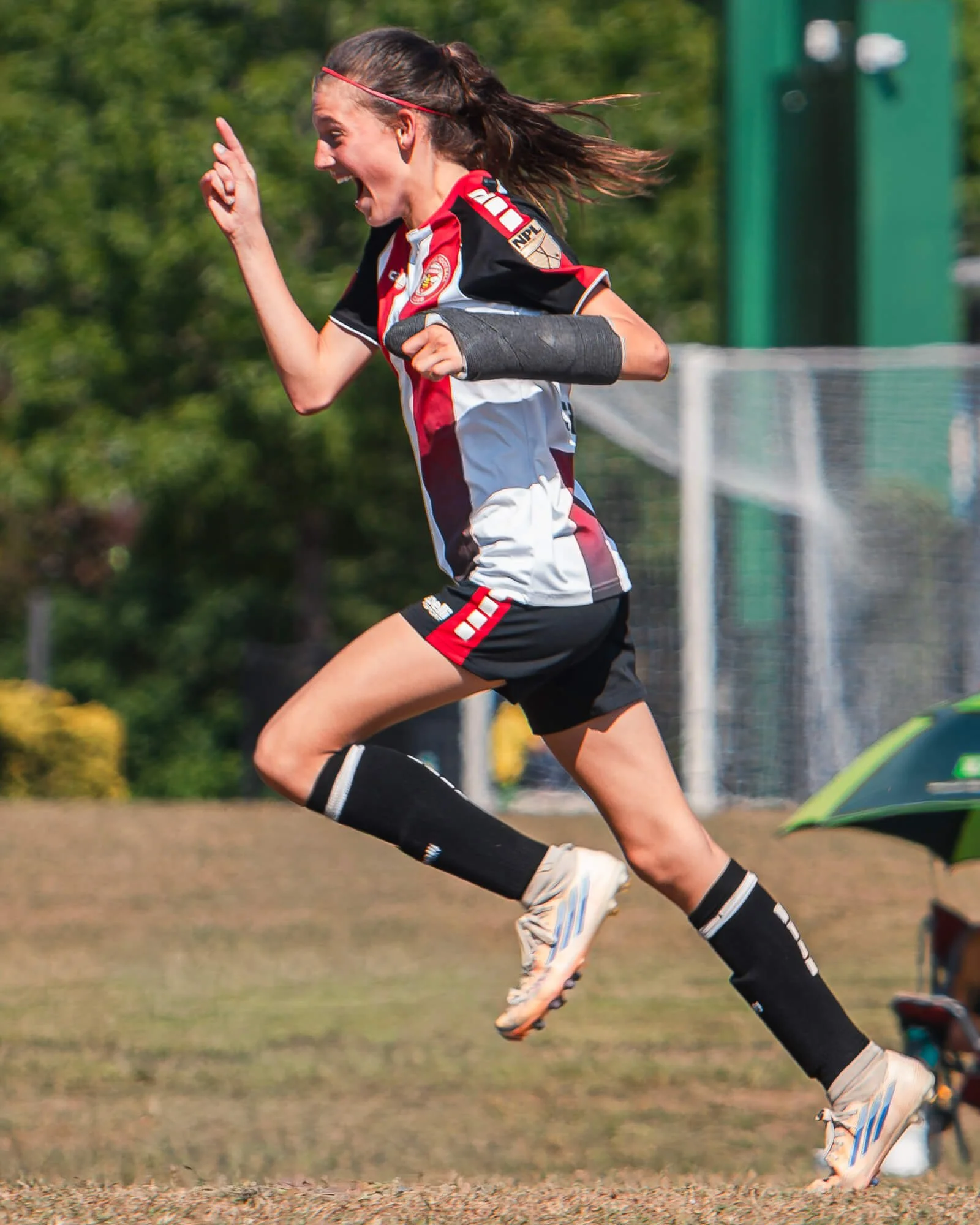 A Carolina Swarm FC youth player celebrates after scoring a goal during a soccer game in Raleigh, North Carolina