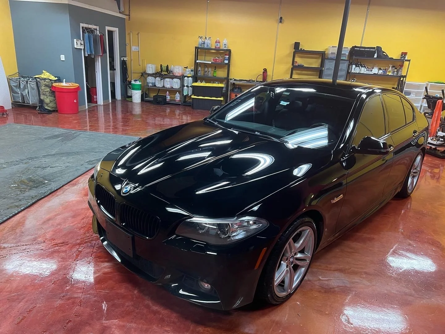 Professional paint correction service removing oxidation and scratches from a vehicle’s paint at Empire Customs Car Detailing.