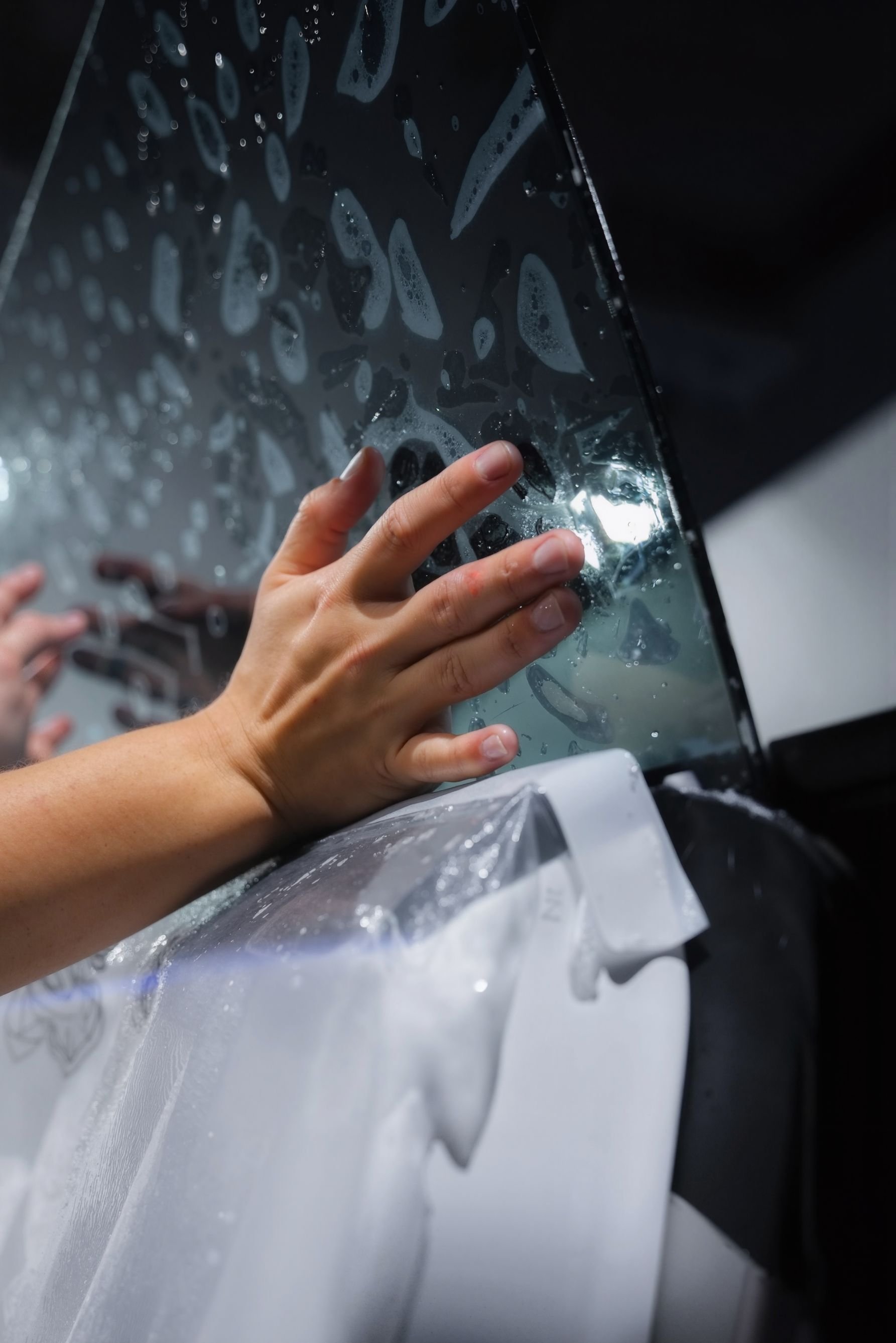 Professional Tesla window tint service showing ceramic film applied to a Tesla windshield for reduced heat and glare.